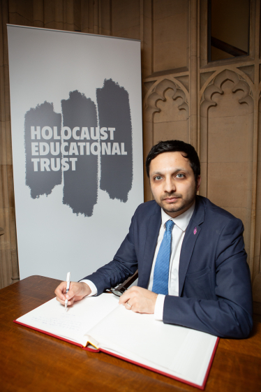 Saqib Bhatti MP signing the Holocaust Educational Trust book of commitment 